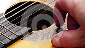 Musician playing acoustic guitar close up shot