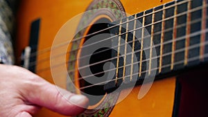 Musician playing acoustic guitar close up shot