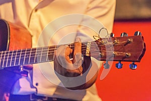 Musician playing acoustic guitar on stage music band in the night