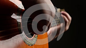 musician playing acoustic guitar strings