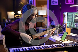 Musician playing acoustic instrument next to greenscreen on smartphone