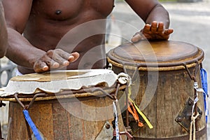 Musician playing atabaque which is a percussion instrument of African origin