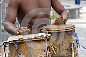 Musician playing atabaque which is a percussion instrument of African origin used in samba, capoeira, umbanda, candomble and other