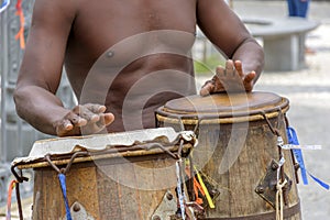 Musician playing atabaque which is a percussion instrument of African origin used in samba, capoeira, umbanda, candomble photo