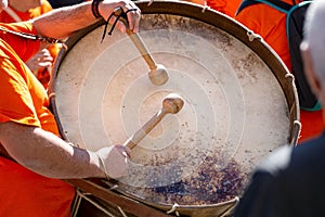 Musician playing a bass drum during an outdoor festival