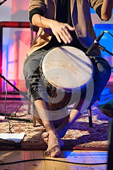 Musician playing djembe drum