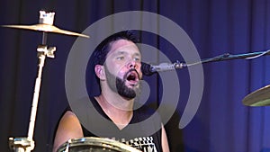 Musician playing drums and cymbals at concert.