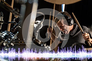 Musician playing drums at sound recording studio