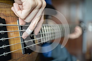 Musician playing electric bass with injured finger