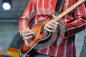 Musician playing on electric guitar