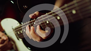 Musician playing electric guitar in studio. Guitarist hand pinching chords