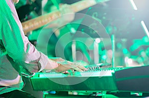 Musician playing electronic keyboard, selective focus