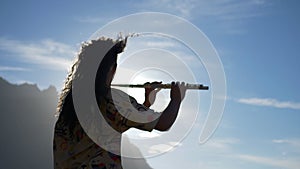 Musician Playing The Flute on a landscape