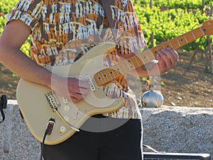 A musician playing the guitar composing beautiful songs