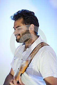 Musician playing guitar with a lot of feeling in studio