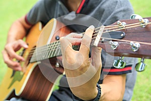 Musician playing guitar in the park