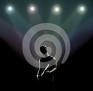 Musician playing the guitar on the stage