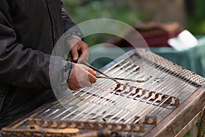 Musician playing hammered dulcimer with mallets