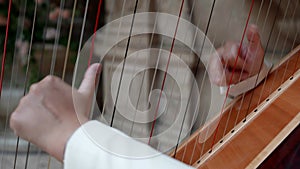 musician is playing harp, classical music, closeup of hands