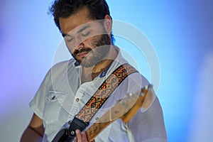 Musician playing his guitar while feeling the music