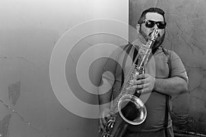 musician playing his tenor saxophone in different places