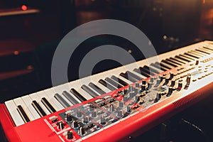 Musician playing on the keyboard synthesizer piano keys. Musician plays a musical instrument on the concert stage.