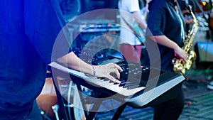 Musician playing on the keyboard synthesizer piano keys. Musician plays a musical instrument on the concert stage