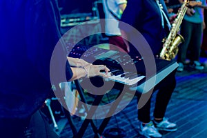 Musician playing on the keyboard synthesizer piano keys. Musician plays a musical instrument on the concert stage