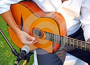 Musician playing a Spanish guitar.