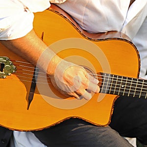 Musician playing a Spanish guitar.