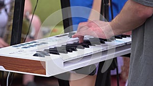 Musician playing the synthesizer at a street music festival. Cover band performing at open air, Keyboardist synthesizer