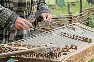 Musician playing traditional hammered dulcimer cymbalo with mallets