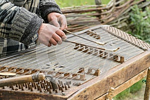 Musician playing traditional hammered dulcimer cymbalo with mallets