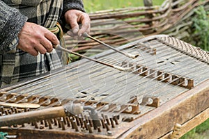 Musician playing traditional hammered dulcimer cymbalo with mallets