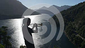 Musician Playing The Trumpet on a landscape