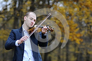 Musician playing at violin photo