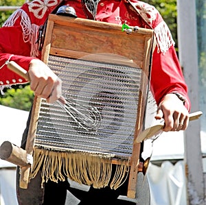 Musician playing washboard with kitchen tools