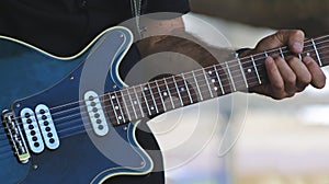 A Musician Plays a Blue Electric Guitar
