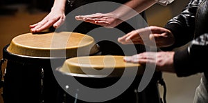 The musician plays the bongo. Close up of musician hand playing bongos drums. Afro Cuba, rum, drummer, fingers, hand