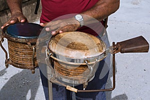 The musician plays the bongos on the boardwalk of Havana Cuba to brighten up the atmosphere. photo