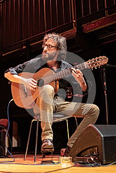 Musician plays Brazilian 7-string guitar on a stage