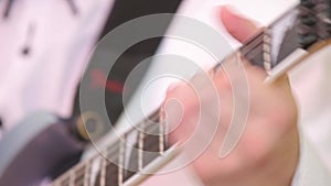 Musician plays the electric guitar. Close up