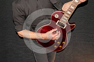 Musician plays with a Gibson Les Paul american standard electric guitar in red