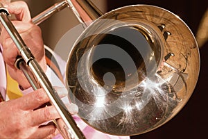 The musician plays a jazz melody on a trombone. Close-up. For music news.