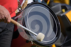 Musician plays the kettledrum in a corps of drums, motion blur