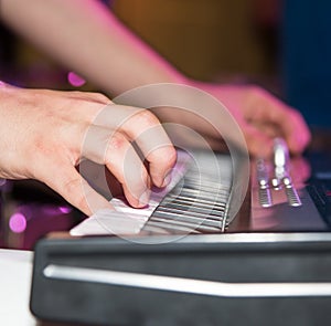 Musician plays keyboards in a rock band