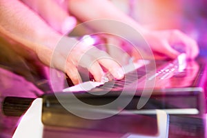 Musician plays keyboards in a rock band