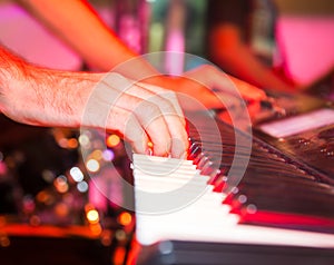 Musician plays keyboards in a rock band