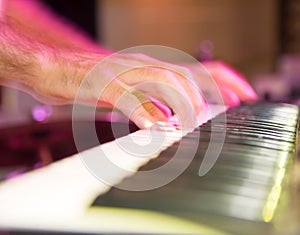 Musician plays keyboards in a rock band