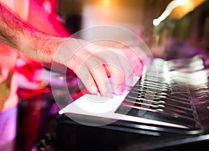 Musician plays keyboards in a rock band